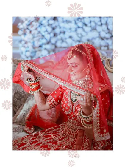 A classic bridal pose, looking down with the veil creating a soft frame. This is a timeless and elegant shot.