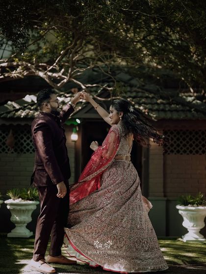 The couple sharing a dance, the bride's lehenga twirling around her in a motion of grace and happiness.