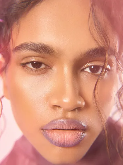 A direct-to-camera beauty portrait using a split diopter. The effect adds a subtle ethereal quality while keeping the focus sharp on the model's eyes and lips.