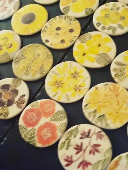 A close up view of my floral coasters, showing the variety of hand painted designs. I never repeat a design, so each coaster is a miniature piece of art. They are a great way to add a touch of handmade beauty to your home.