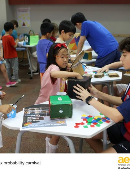 Learning becomes a game at the Grade 7 Probability Carnival. Here, younger students try out a game designed and built by middle schoolers to demonstrate concepts of theoretical probability.