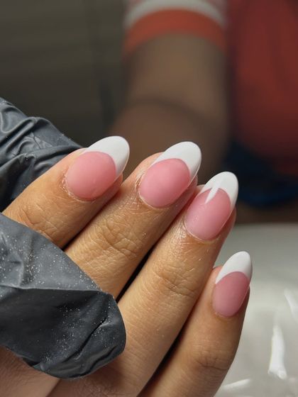 A close-up of the sharp, clean lines on these classic French tips. Perfection is in the details.