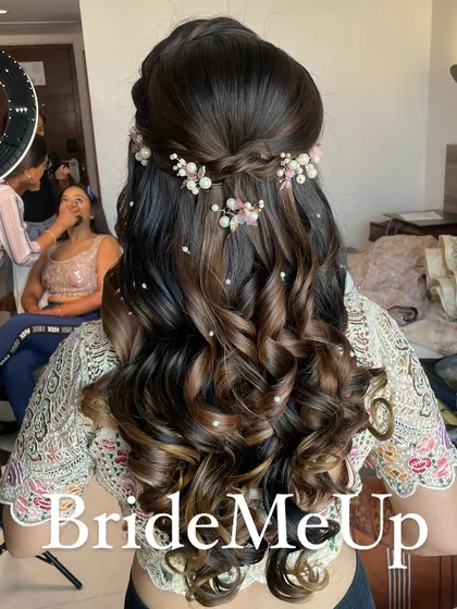 A detailed look at the half-up hairstyle for my engagement bride Pratishtha. The braid is adorned with delicate pink and white floral accessories.