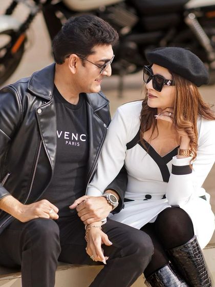 A close-up of the couple, showing her chic makeup and sunglasses. This look is perfect for a sunny, outdoor pre-wedding shoot.