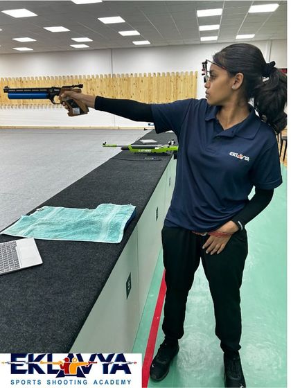 A young pistol shooter demonstrates excellent form and concentration during practice. We nurture this focus from a young age, building the foundation for future success.