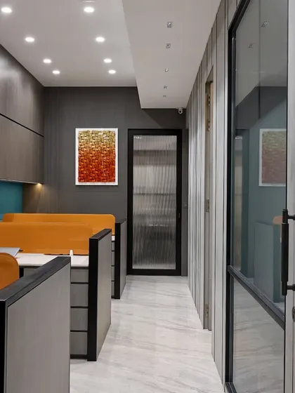 A well-organized workspace is key to efficiency. This corridor in a modern office shows how we use glass doors and consistent wall paneling to create a seamless and professional look.