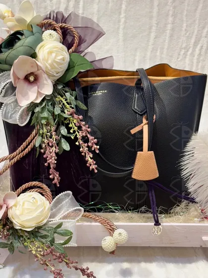 A different angle of the black tote bag, showing how the floral arrangement and tray work together to create a stunning presentation.