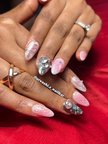 This fairycore-inspired set is all about pink dreams and crystal wings. It combines shimmering chrome, soft 3D butterfly wings, a cute sculpted bow, and a massive crystal accent nail for a magical look.