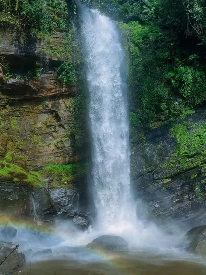 The stunning Didupe Falls, with a rainbow forming in its mist. It's a magical sight on our Charmadi ghat treks.