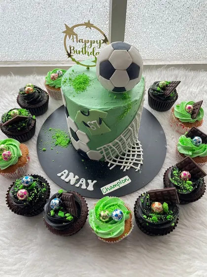 A complete party set for a young football fan. This order included a custom football-themed cake with a net and jersey design, along with matching cupcakes to create a full dessert table for the birthday boy.