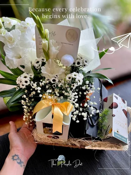 Simple, understated, and elegant. This hamper, combining fresh flowers with curated gifts, is a signature style perfect for celebrating clients and partners with a touch of love.