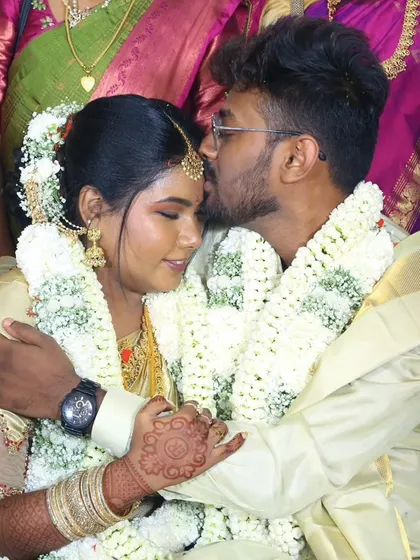 A sweet, candid moment between the bride and groom. Her makeup looks flawless even in this close-up, emotional shot.