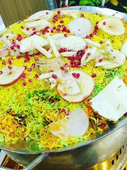 An example of my specialty main courses, this is a colorful Kashmiri Pulao. It's a fragrant rice dish cooked with fruits, nuts, and saffron, offering a flavorful vegetarian option for your guests.