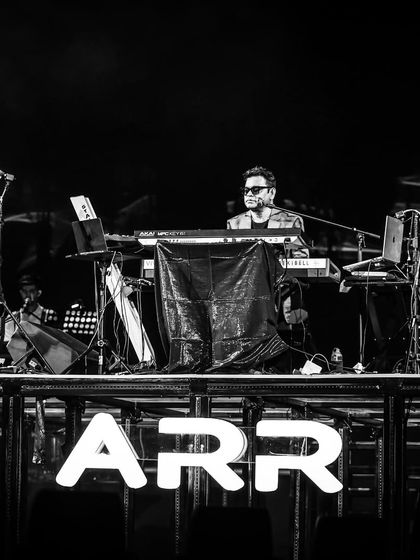 A timeless black and white portrait of the maestro, A.R. Rahman, at his keyboard during the concert. We focus on capturing these powerful, intimate moments that define the legacy of an event.