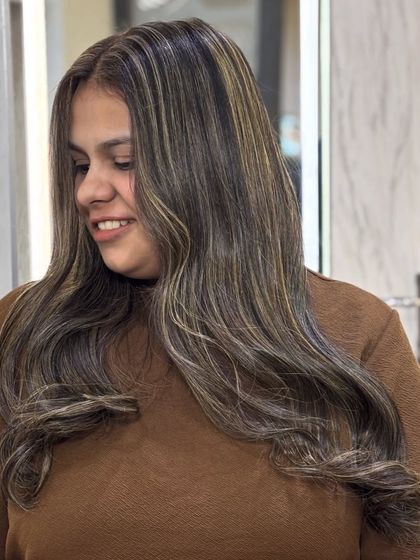 The client's happy smile after her creamy beige ash transformation. The color is soft, flattering, and modern.