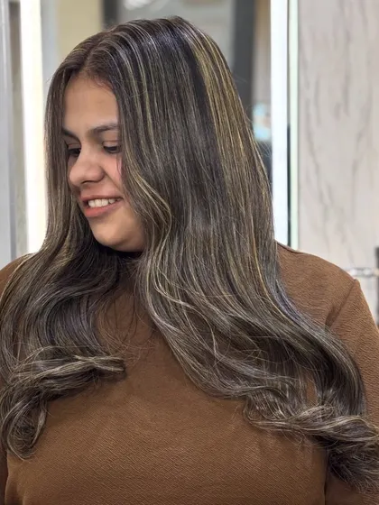 The client is glowing with her new creamy beige hair. This color has brightened up her whole look, giving her a fresh and modern style.