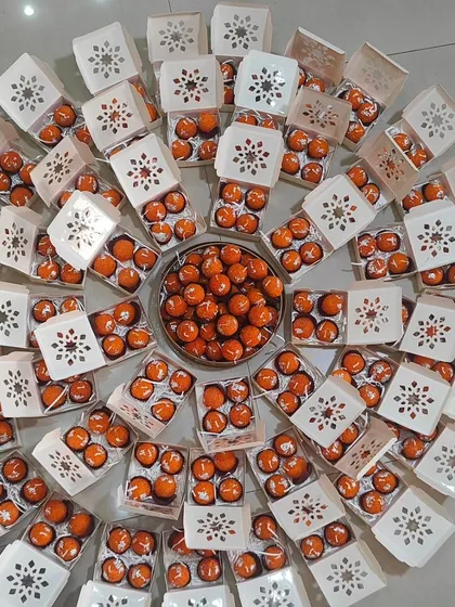 A large batch of my motichoor ladoo candles, arranged in a circle. These are perfect for bulk orders for Diwali or wedding favors.