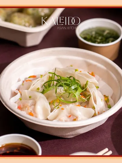 A bowl of our delicate steamed wontons, garnished with fresh spring onions. These dumplings are served in a light broth, making for a comforting and flavorful appetizer.