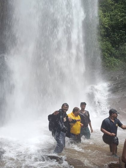 Trekkers having a great time in the powerful currents at the base of Hidlumane Falls during our Kodachadri trek.