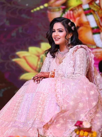 The full-length view of this stunning engagement lehenga. The soft, flowing fabric and intricate embroidery are perfectly complemented by the romantic makeup and hairstyle.