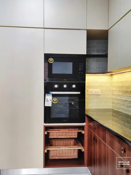 Every detail is considered for convenience. This tall pantry unit features a built-in oven and microwave, along with pull-out wicker baskets that provide accessible, breathable storage for vegetables or linens.