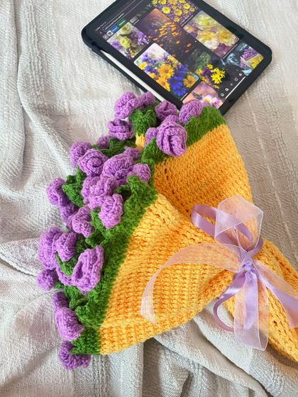 A different view of the bouquet blanket, showing it folded up and tied with a ribbon. It truly looks like a giant bouquet of flowers.