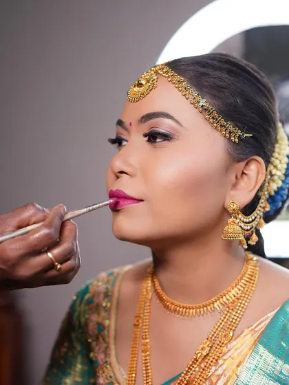 A shot of me in action, applying the perfect lip color for Arpitha. This close-up shows the precision and care I take with every step.