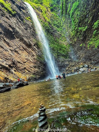 A beautiful shot of Koodluthirtha Falls with balanced stones in the foreground, creating a sense of peace and tranquility.