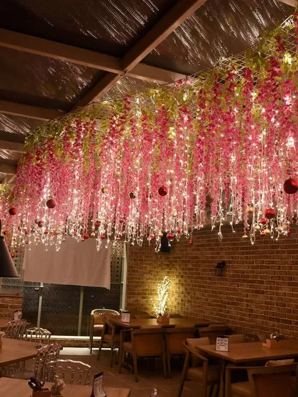 Another shot of the magical pink floral ceiling, showing how the fairy lights and hanging flowers transform the entire restaurant space.