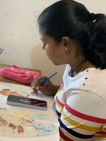 A student works on a portrait, her palette knife and paints ready. The calm, focused atmosphere of our classroom allows for deep concentration and creative exploration.