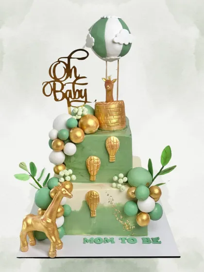 Welcoming a new baby is a huge deal, and the cake should be just as special. This whimsical safari-themed baby shower cake, with its golden animals and hot air balloon, is all about celebrating new adventures.