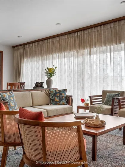 The 'Gulmohar' living and dining area is arranged linearly to take advantage of the balcony view. A custom crockery unit separates the two zones while maintaining an open feel.