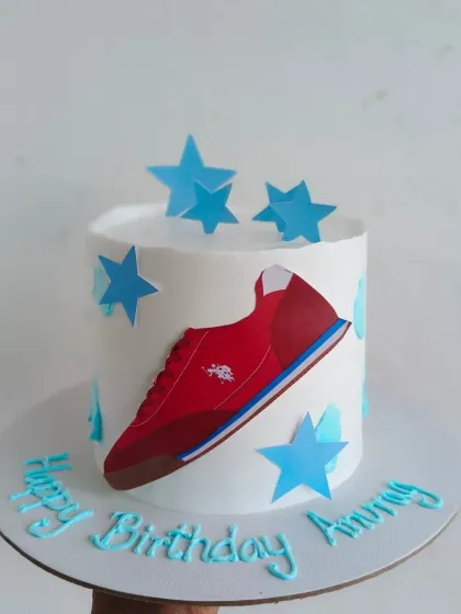 A cake themed around the USPA brand for a boss's birthday, featuring the shoe logo.