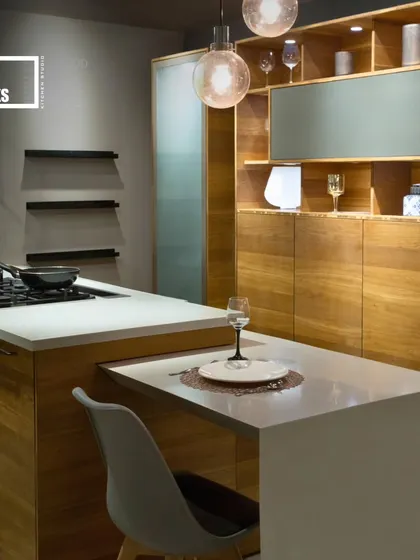 This kitchen island includes a clever pull-out table, providing a flexible dining or work surface that can be tucked away when not in use.