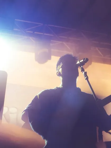A silhouette shot against the bright stage lights in Goa. This captures the epic feeling of being on stage and performing for a live audience.