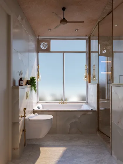 This guest bathroom features marble-clad walls and a bathtub with a large window, creating a bright and luxurious feel. Gold fixtures and pendant lights add a touch of warmth and sophistication.