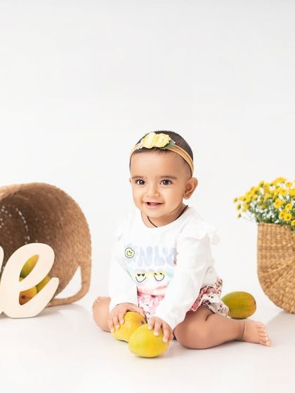 A mango themed one year milestone session. Incorporating your baby's favorite fruits or toys is a great way to ensure they have fun and give us those precious, natural smiles.