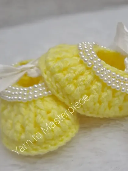 Another angle of the cheerful yellow pearl booties, perfect for adding a pop of color to any baby outfit.