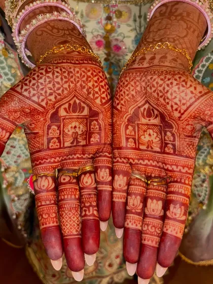 The beautiful result of my all-natural, herbal mehndi paste and proper aftercare. This photo showcases the deep, rich maroon stain of a full bridal design, highlighting the intricate lotus and geometric patterns on the fingers and palms.