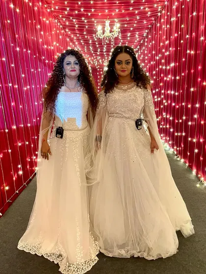 A full-length view of our flowing white gowns against a backdrop of fairy lights. It felt like a fairytale.