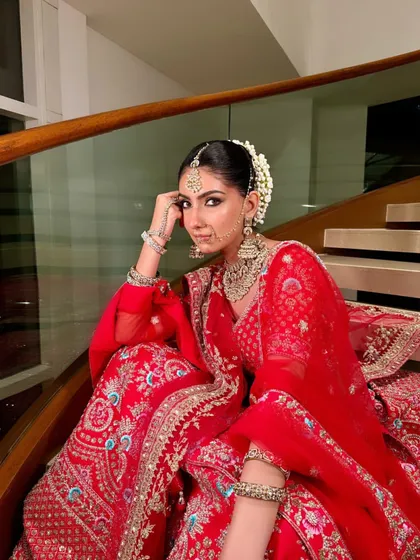 A candid moment of the bride, her expression full of grace. The makeup highlights her features without overpowering them, true to my philosophy of enhancing natural beauty.