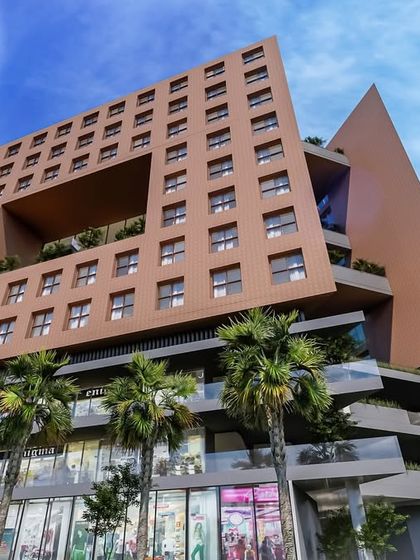 This render showcases a residential structure where the building's "skin" adapts to its environment. The design blends functionality with minimal environmental impact, featuring retail at the base and apartments with green terraces above.