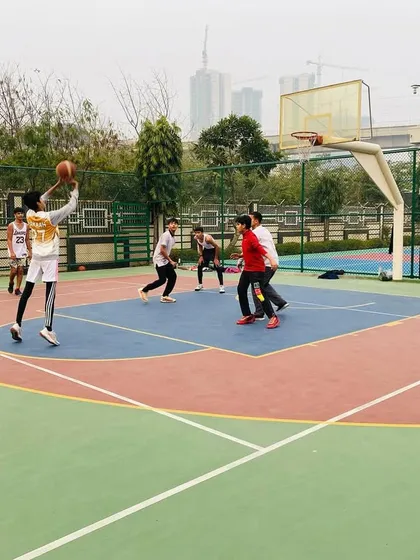 A player takes a jump shot, focusing on form and follow-through.