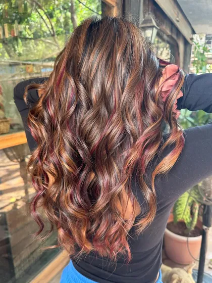 Another angle of the caramel and red peekaboo hair. The red adds a fun and unexpected pop of color.
