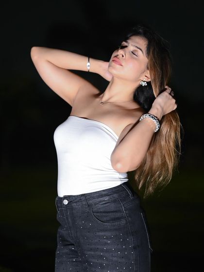 An expressive pose that adds a touch of glamour to the night shoot.