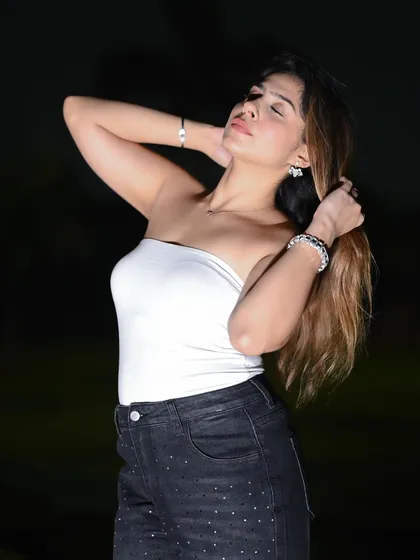 An expressive pose that adds a touch of glamour to the night shoot.