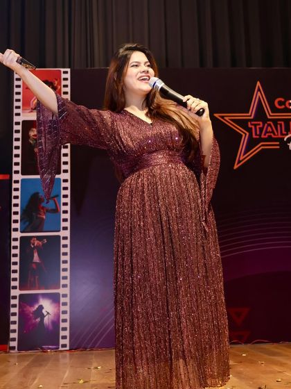 Singing and engaging with the crowd during the talent hunt. I often join in the performances to encourage the participants.