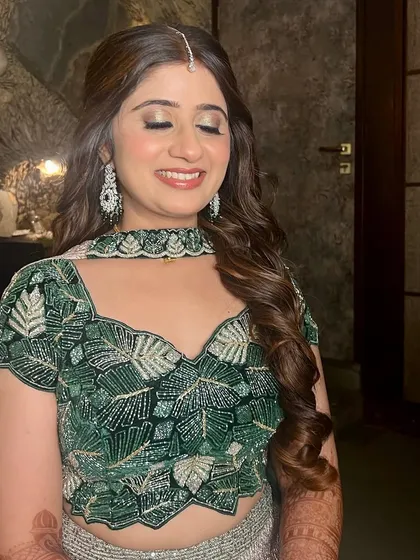 A close-up of the radiant sangeet look, showing the shimmery eyeshadow and glowing skin.