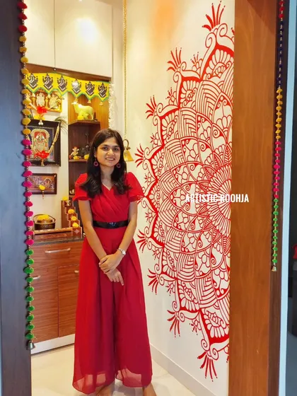 A festive red mandala mural painted to celebrate Diwali. This piece, placed near the home mandir, adds a vibrant and auspicious touch to the home's decor during the festival of lights.