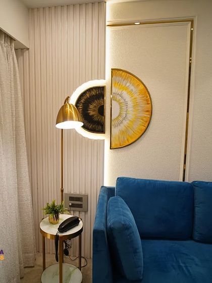 A closer look at the details. The textured wall paneling, unique semi-circular wall art, and elegant floor lamp add layers of sophistication to this living room design.